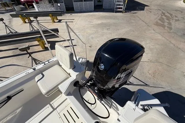 Slide: The Image of 2018 Boston Whaler 170 Montauk boat with Mercury outboard motor, docked on concrete. - 21