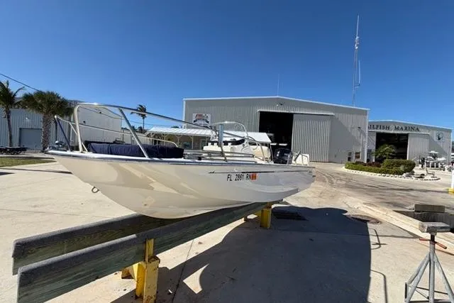 Slide: The Image of 2018 Boston Whaler 170 Montauk boat at a marina under clear blue skies. - 4