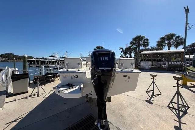 Slide: The Image of 2018 Boston Whaler 170 Montauk boat docked, featuring a 115 HP engine, under clear blue sky. - 6