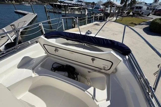 Slide: The Image of 2018 Boston Whaler 170 Montauk boat with open storage compartment at marina. - 8
