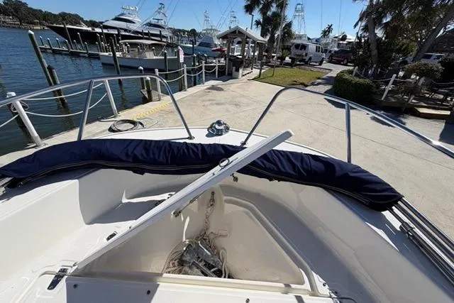 Slide: The Image of 2018 Boston Whaler 170 Montauk boat docked at marina with scenic waterfront view. - 9