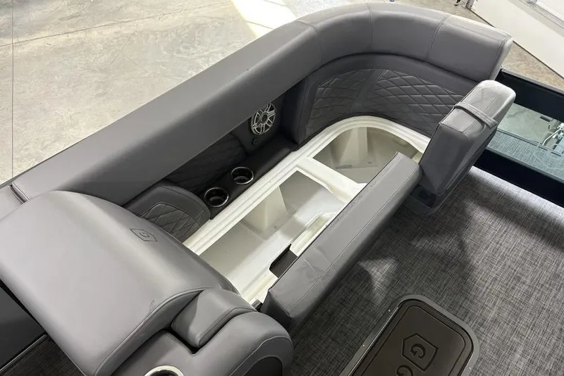 Slide: The Image of Luxurious seating on 2026 Godfrey Monaco 235 SB iMPACT pontoon boat, featuring storage and cup holders. - 10