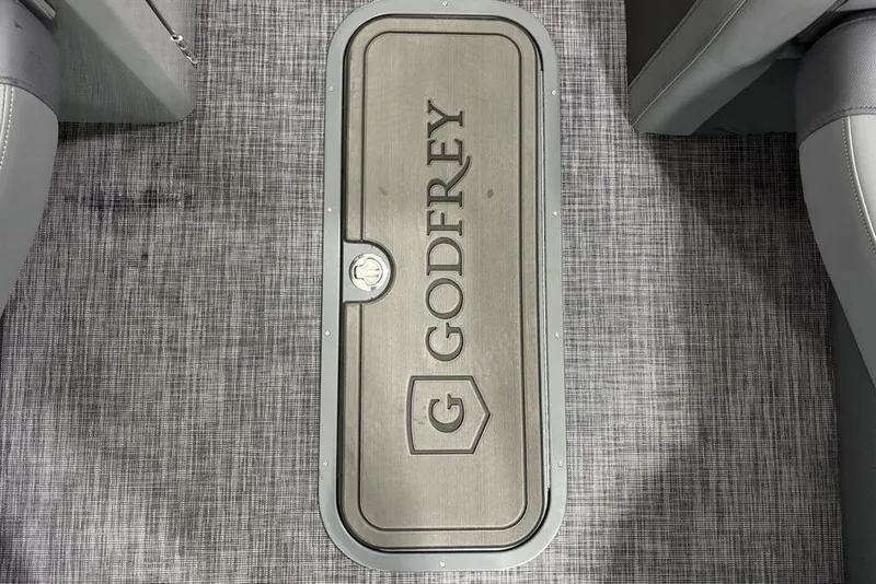 Slide: The Image of Floor hatch of 2026 Godfrey Monaco 235 SB iMPACT pontoon boat, featuring logo and textured flooring. - 11