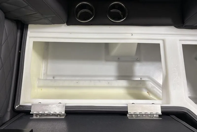 Slide: The Image of Interior storage compartment of 2026 Godfrey Monaco 235 SB iMPACT boat with cup holders. - 12