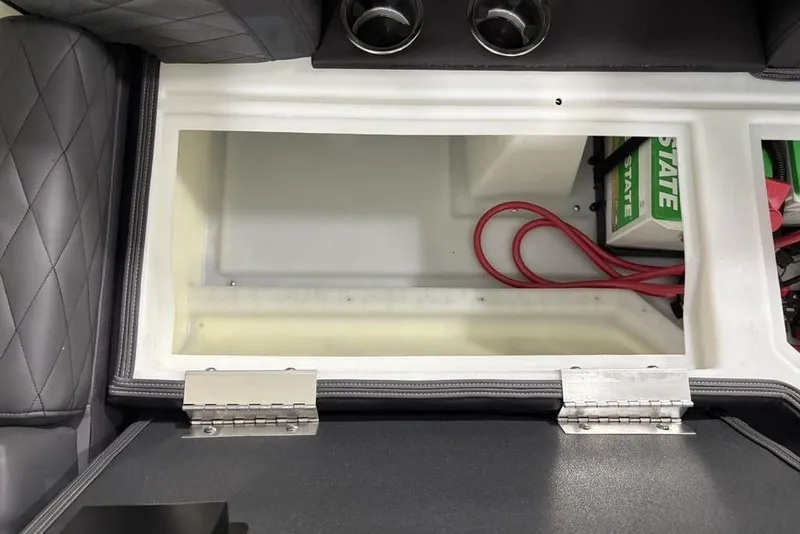 Slide: The Image of Storage compartment of 2026 Godfrey Monaco 235 SB iMPACT pontoon boat, featuring battery and cables. - 34