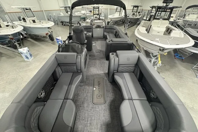 Slide: The Image of 2026 Godfrey Monaco 235 SB iMPACT pontoon boat interior in showroom, featuring luxurious seating. - 37