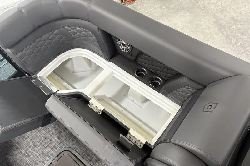 Slide: The Image of 2026 Godfrey Monaco 235 SB iMPACT boat interior with storage compartment and cup holders. - 6