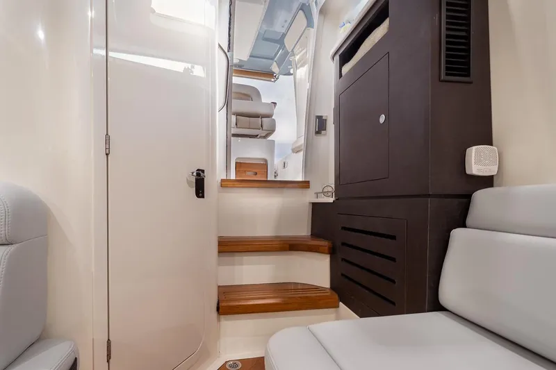 Slide: The Image of Manufacturer Provided Image: Interior of 2026 Boston Whaler 350 Realm, featuring wooden steps and modern seating. - 13