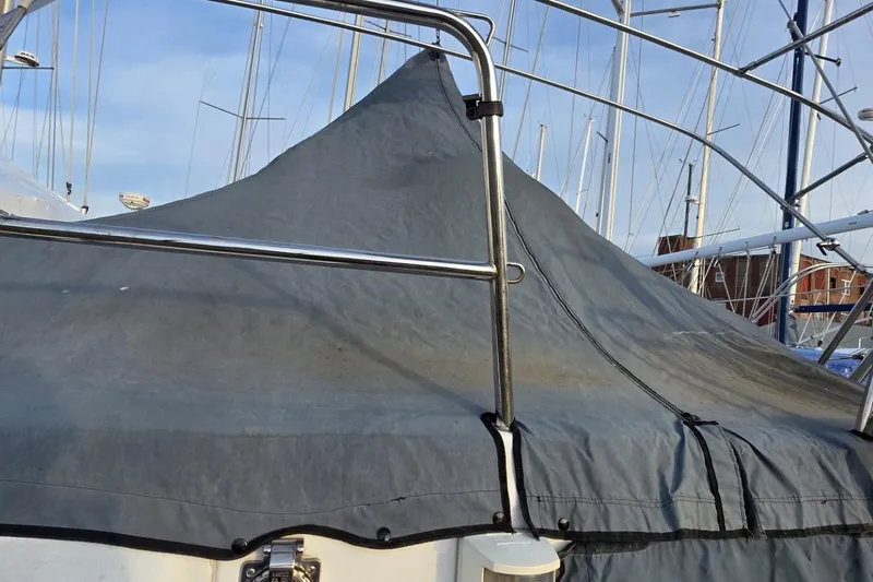 Slide: The Image of Beneteau Oceanis Clipper 423 (2003) with protective cover in marina setting. - 13