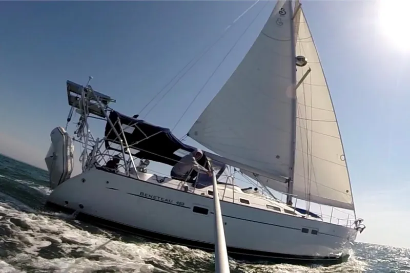 Slide: The Image of Sailing yacht Beneteau 423, 2003 model, navigating ocean waters under clear skies. - 19
