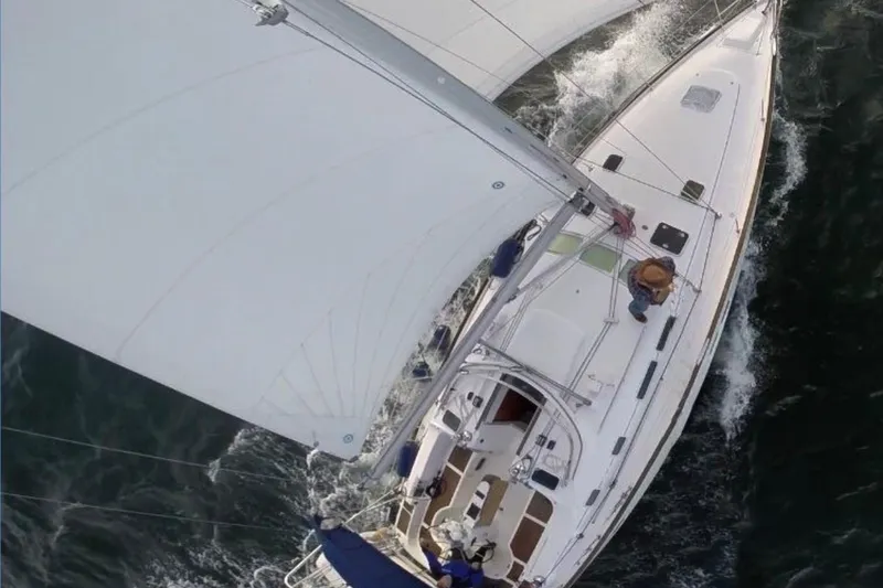Slide: The Image of Aerial view of 2003 Beneteau 423 sailboat navigating through water. - 20