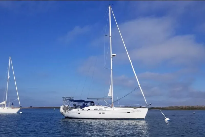 Slide: The Image of Sailing yacht Beneteau 423, 2003 model, anchored on calm waters under a clear blue sky. - 21