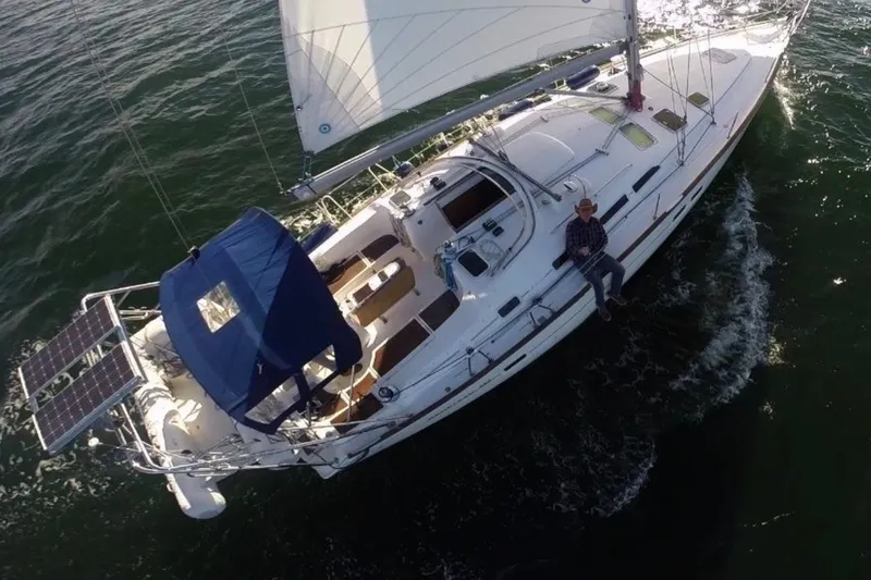 Slide: The Image of Aerial view of a 2003 Beneteau 423 sailboat navigating through water. - 22