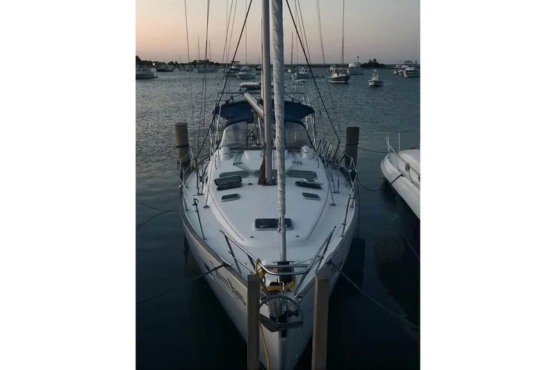 Slide: The Image of Sailboat Beneteau 423, 2003 model, docked at sunset with other boats nearby. - 25