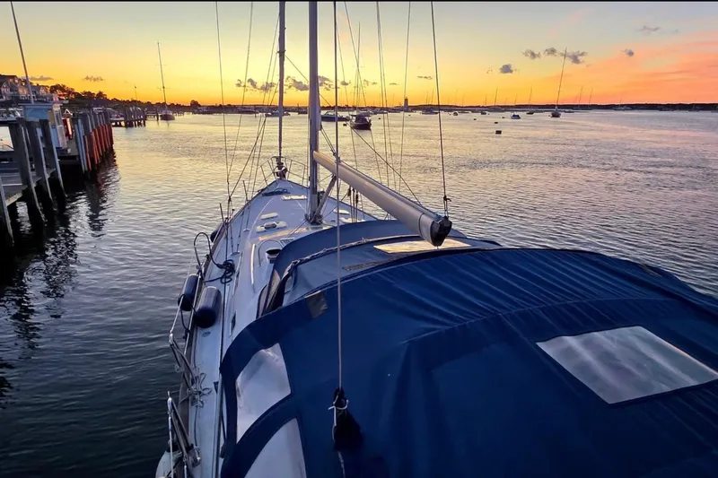 Slide: The Image of Sailboat Beneteau 423 (2003) docked at sunset, calm waters, scenic view. - 26