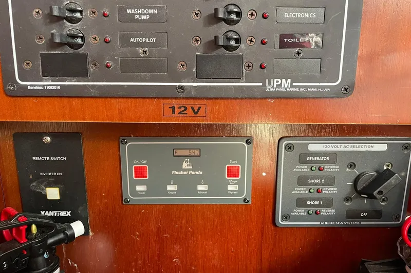 Slide: The Image of Electrical control panel on a 2003 Beneteau 423 yacht, featuring various switches and indicators. - 36