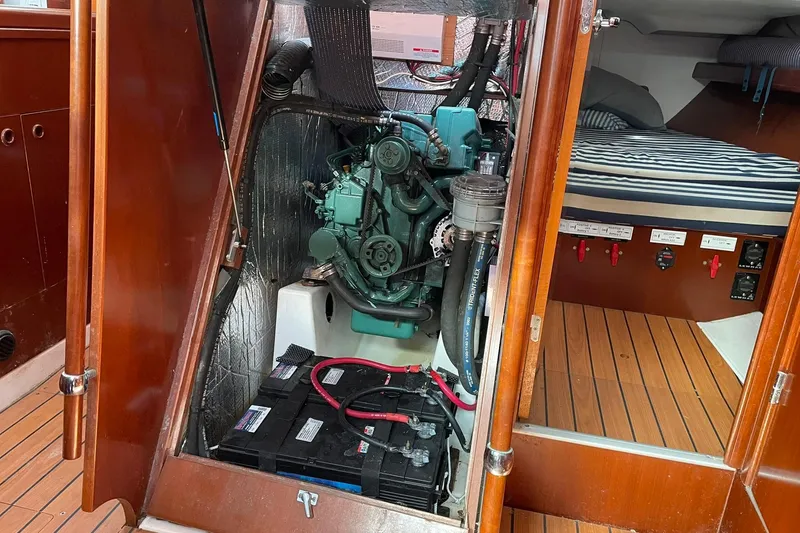 Slide: The Image of Engine room of a 2003 Beneteau 423 sailboat with visible engine and battery. - 37