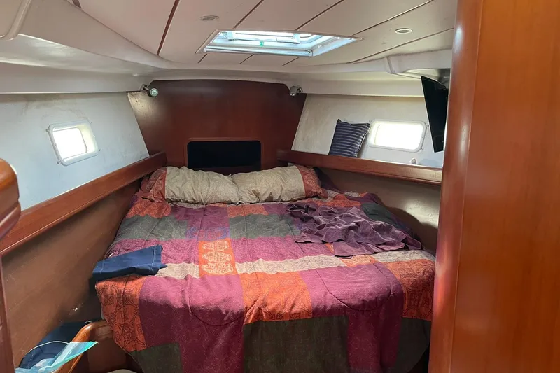 Slide: The Image of Cozy cabin interior of a 2003 Beneteau 423 sailboat with colorful bedding. - 39
