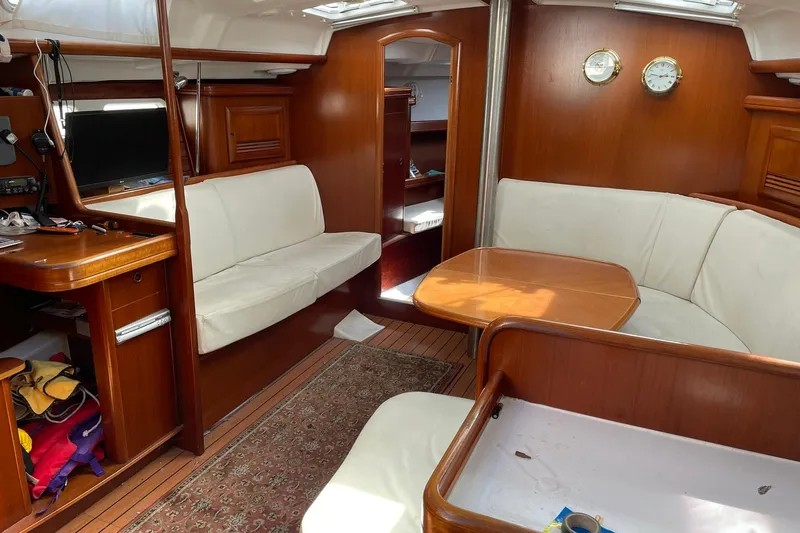 Slide: The Image of Interior of 2003 Beneteau 423 yacht with wooden furnishings and white seating. - 40
