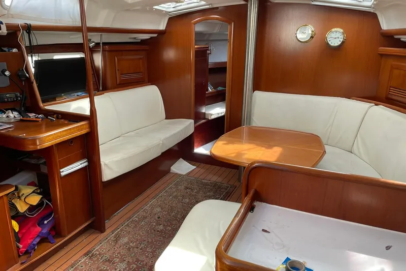 Slide: The Image of Interior of 2003 Beneteau 423 yacht with wooden furnishings and white seating. - 44