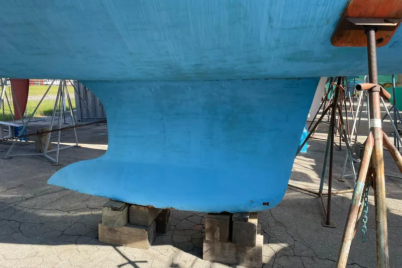 Slide: The Image of Blue hull of a 2003 Beneteau 423 sailboat on stands in a boatyard. - 47