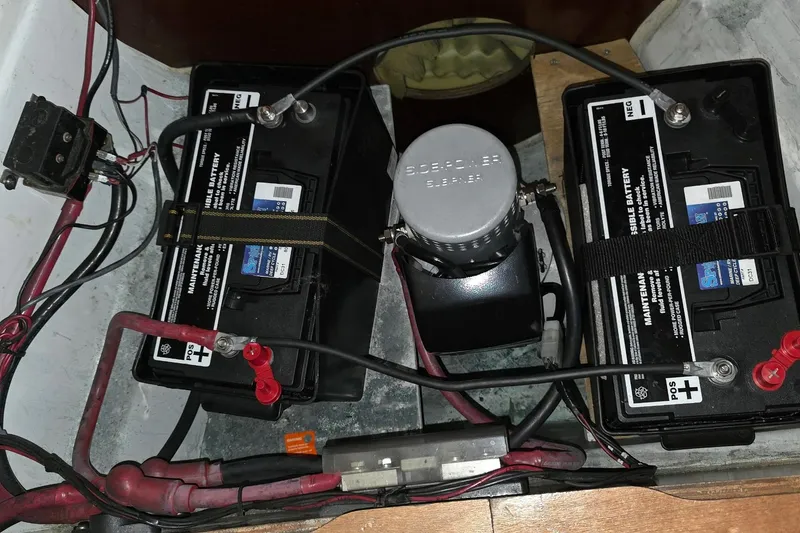 Slide: The Image of Battery setup in a 2003 Beneteau 423 sailboat, featuring dual marine batteries and wiring. - 50