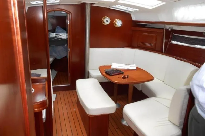 Slide: The Image of Interior of 2003 Beneteau Oceanis Clipper 423 yacht with wooden finish and white seating. - 4