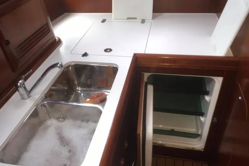 Slide: The Image of Galley kitchen in 2003 Beneteau Oceanis Clipper 423 yacht with sink and storage. - 5