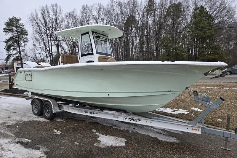 The Image of 2026 Sea Hunt Ultra 275 SE boat on trailer, parked outdoors in winter setting. - 0