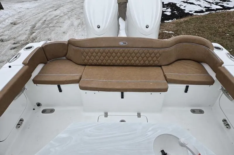 Slide: The Image of 2026 Sea Hunt Ultra 275 SE boat with tan cushioned seating and dual engines. - 11