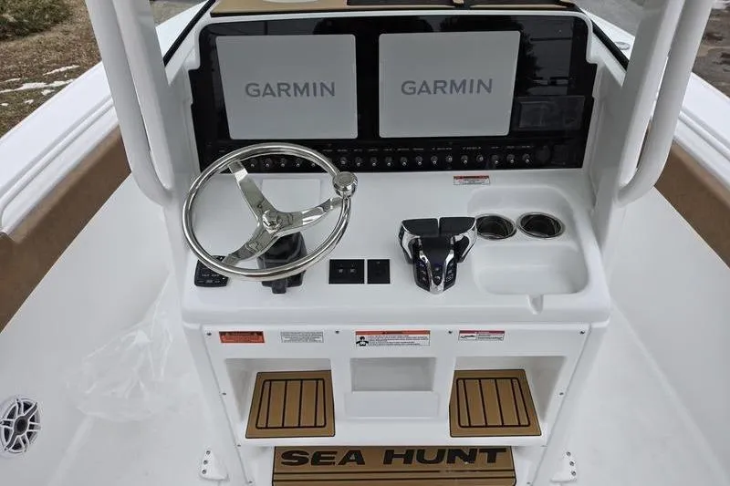 Slide: The Image of 2026 Sea Hunt Ultra 275 SE boat dashboard with dual Garmin displays and steering wheel. - 9