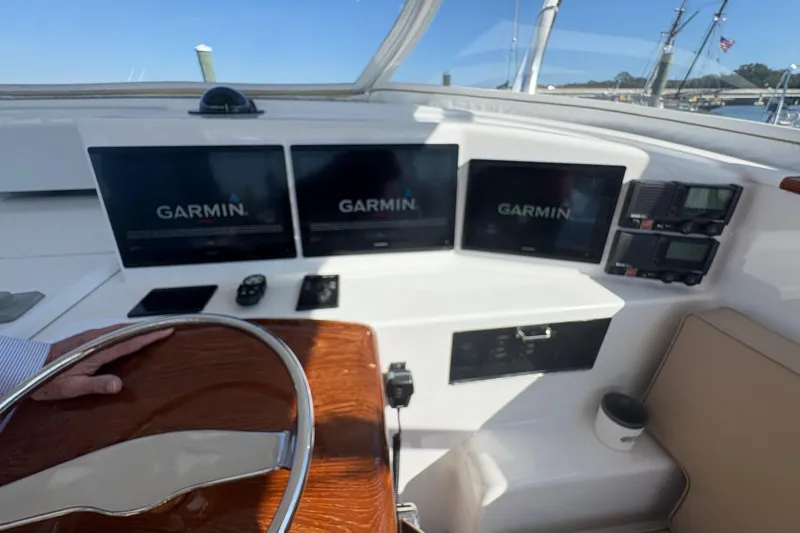 Slide: The Image of Helm of 1991 Garlington 44 Express with Garmin navigation displays and wooden steering wheel. - 13