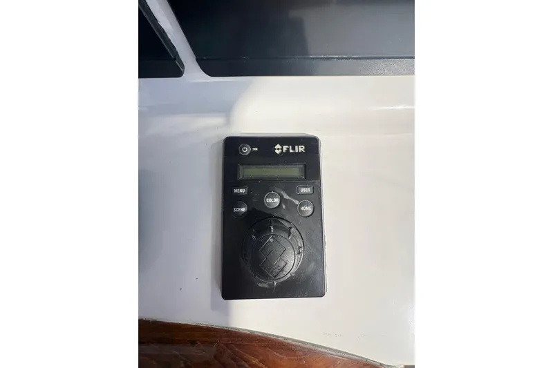 Slide: The Image of FLIR control panel on 1991 Garlington 44 Express yacht dashboard. - 14