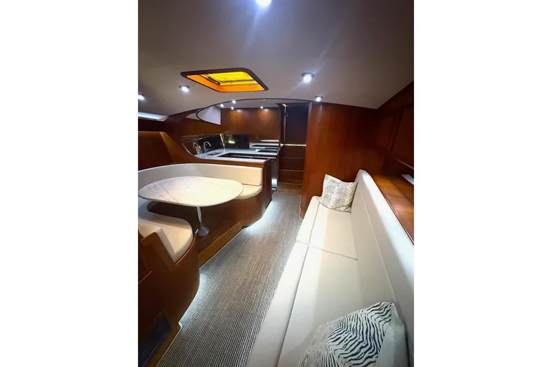 Slide: The Image of Luxurious interior of 1991 Garlington 44 Express yacht with elegant wood finishes and cozy seating. - 16