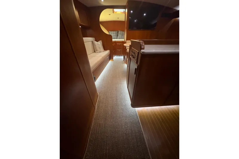 Slide: The Image of Interior of 1991 Garlington 44 Express yacht with elegant wood finish and cozy seating. - 18