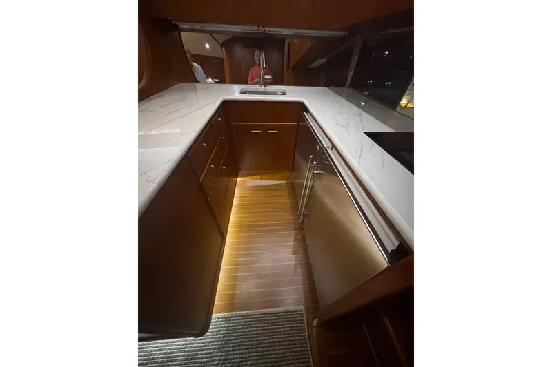 Slide: The Image of Luxurious kitchen interior of 1991 Garlington 44 Express yacht with modern design and lighting. - 21