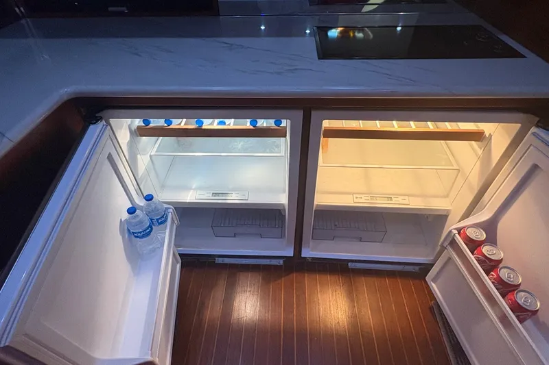 Slide: The Image of Dual open refrigerators on a 1991 Garlington 44 Express yacht, stocked with drinks. - 22