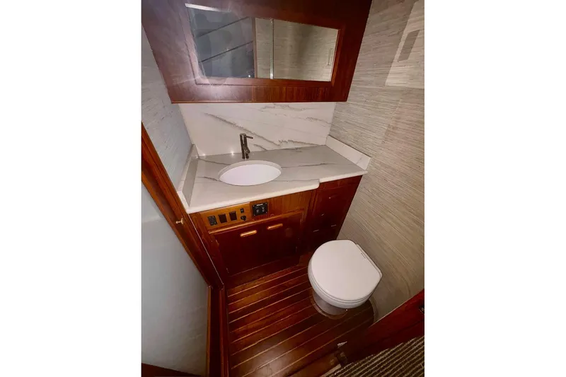 Slide: The Image of Luxurious bathroom in 1991 Garlington 44 Express yacht with wood accents and modern fixtures. - 26
