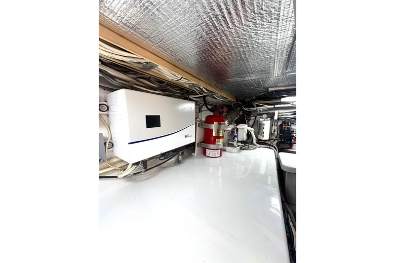 Slide: The Image of Engine room of 1991 Garlington 44 Express yacht with equipment and wiring. - 30