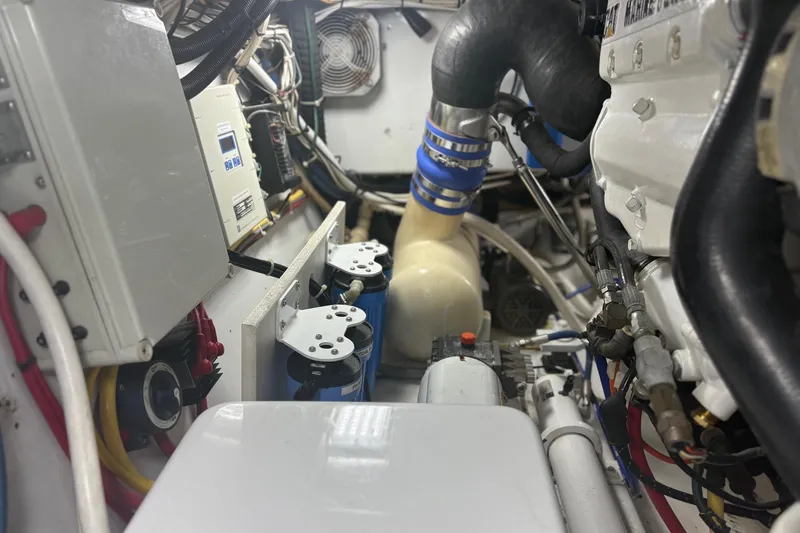 Slide: The Image of Engine room of a 1991 Garlington 44 Express boat, showcasing mechanical components and wiring. - 32