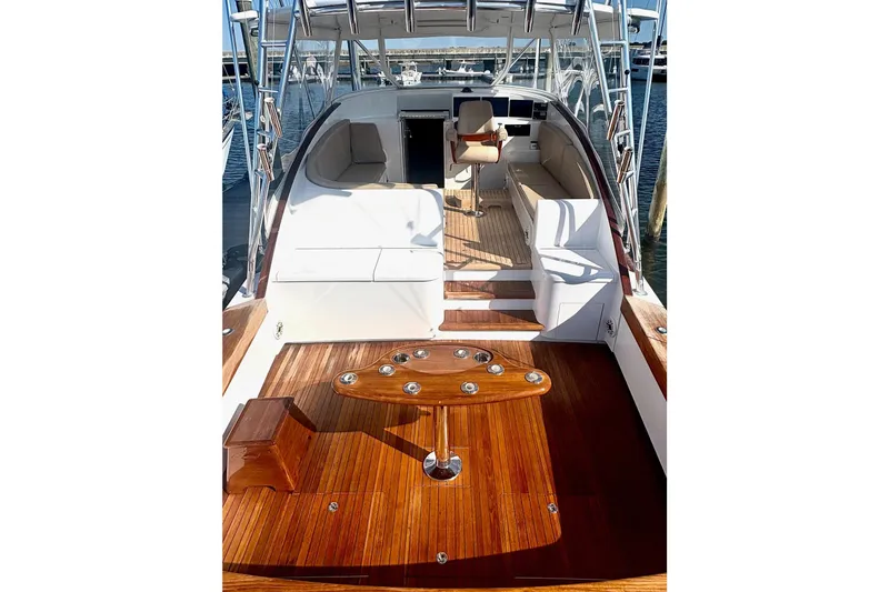 Slide: The Image of 1991 Garlington 44 Express yacht with polished wood deck and seating area. - 7
