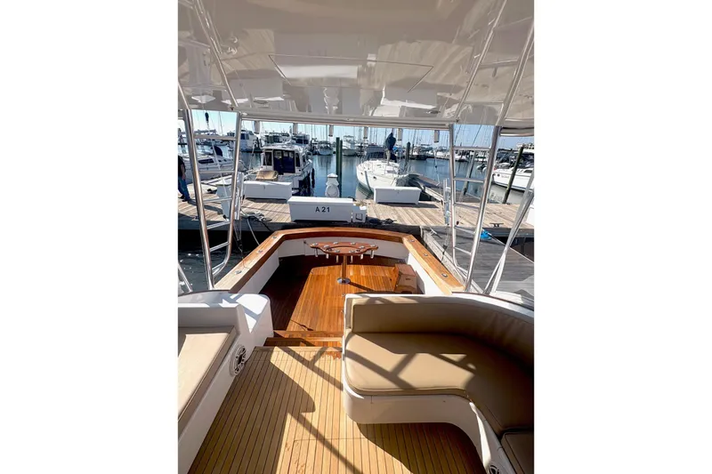 Slide: The Image of 1991 Garlington 44 Express yacht interior with wooden deck at marina. - 8