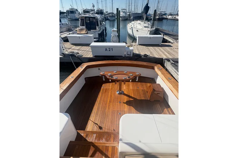 Slide: The Image of 1991 Garlington 44 Express boat with wooden deck at marina. - 9