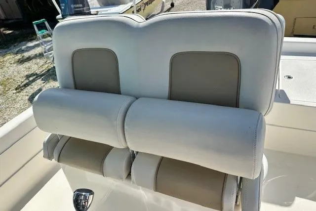 Slide: The Image of ShearWater 25 LTD 2014 boat seating with beige and white upholstery. - 14