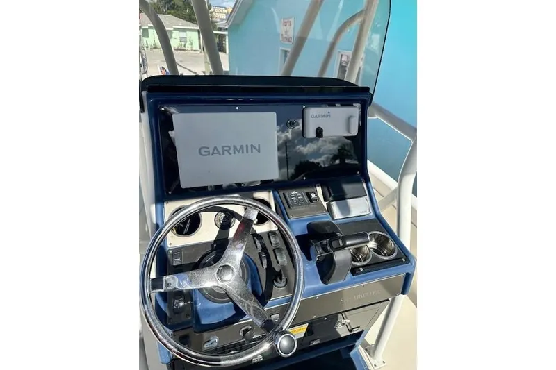 Slide: The Image of 2014 ShearWater 25 LTD boat console with Garmin navigation system and steering wheel. - 15
