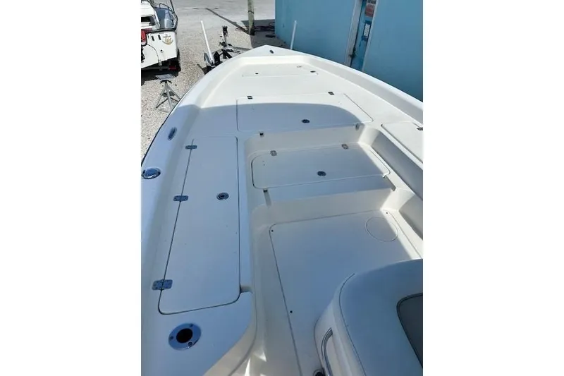 Slide: The Image of 2014 ShearWater 25 LTD boat deck with storage compartments, white finish. - 21