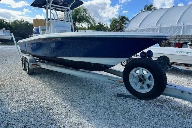 Slide: The Image of 2014 ShearWater 25 LTD boat on trailer, parked outdoors under blue sky. - 3