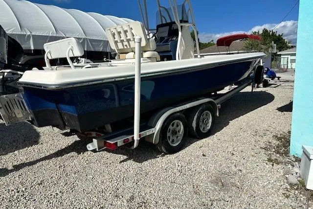 Slide: The Image of 2014 ShearWater 25 LTD boat on trailer, parked outdoors under clear blue sky. - 5