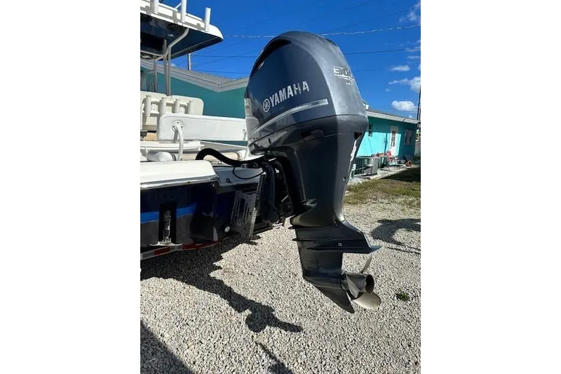 Slide: The Image of 2014 ShearWater 25 LTD boat with Yamaha outboard motor, parked on gravel. - 9