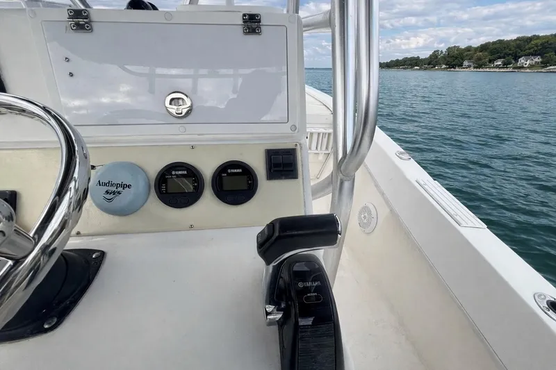 Slide: The Image of Control panel of a 2017 Dusky 252 boat with Yamaha gauges on open water. - 10